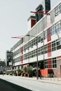 a-large-building-with-many-windows-on-the-side-of-it-3qjcrmch8rc